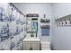 Stylish bathroom with ship-themed shower curtain, single sink vanity, and decorative shelving at 8581 N Goat Hollow Rd, Mooresville, IN 46158
