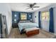 Bedroom with large window, patterned wallpaper, and a cozy queen-size bed and chest at the foot at 8581 N Goat Hollow Rd, Mooresville, IN 46158