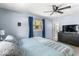 Primary bedroom with blue walls, two windows, and a view of backyard and side yard at 8581 N Goat Hollow Rd, Mooresville, IN 46158