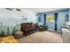 Bedroom decorated with a forest mural, crib, arm chair, and views of the backyard at 8581 N Goat Hollow Rd, Mooresville, IN 46158