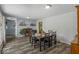 Bright dining room with hardwood floors, large windows, stylish decor, and seating for six guests at 8581 N Goat Hollow Rd, Mooresville, IN 46158
