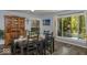 Dining room with hardwood floors, natural light, seating for six, and views of the outdoor living area at 8581 N Goat Hollow Rd, Mooresville, IN 46158