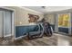 A multipurpose room with an exercise bike, shelving, massage chair and a view of the backyard at 8581 N Goat Hollow Rd, Mooresville, IN 46158