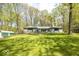 Charming home with lush lawn, flagpole, and inviting green-trimmed exterior at 8581 N Goat Hollow Rd, Mooresville, IN 46158