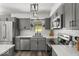 Modern kitchen with gray cabinets, stainless steel appliances, subway tile backsplash, and white countertops at 8581 N Goat Hollow Rd, Mooresville, IN 46158
