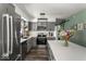 Open kitchen featuring stainless steel appliances, tile backsplash, and a large island with white countertop at 8581 N Goat Hollow Rd, Mooresville, IN 46158