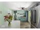 Bright kitchen with light green walls, stainless steel appliances, and an island featuring white countertops at 8581 N Goat Hollow Rd, Mooresville, IN 46158