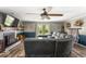 Comfortable living room with a brick fireplace, ceiling fan, and a large sectional sofa at 8581 N Goat Hollow Rd, Mooresville, IN 46158