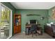 Bright office with green walls, laminate flooring, and a sliding door to the outside at 8581 N Goat Hollow Rd, Mooresville, IN 46158