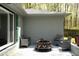 A cozy outdoor patio featuring stylish wicker seating and a modern fire pit for relaxing and entertaining guests at 8581 N Goat Hollow Rd, Mooresville, IN 46158
