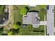 Aerial view of a home with a large, well-maintained yard, mature trees, and a serene pond at 8635 Nolan Dr, Fishers, IN 46038