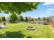 Well-manicured lawn with a fire pit and a tranquil pond view at 8635 Nolan Dr, Fishers, IN 46038
