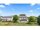 Spacious backyard with a well-kept lawn, mature trees, a deck, and an enclosed porch at 8635 Nolan Dr, Fishers, IN 46038