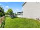 A well maintained backyard with a trampoline and view of the home's sunroom at 8635 Nolan Dr, Fishers, IN 46038