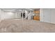 Large finished basement with carpet, neutral walls, a kitchenette area, and stairs at 8635 Nolan Dr, Fishers, IN 46038