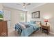 Cozy bedroom with neutral walls, carpet, ceiling fan, and natural light at 8635 Nolan Dr, Fishers, IN 46038