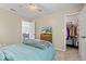 Bedroom with carpet, ceiling fan, and an open closet for ample storage at 8635 Nolan Dr, Fishers, IN 46038