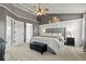 Bright bedroom with a tufted headboard, a ceiling fan, and recessed paneling at 8635 Nolan Dr, Fishers, IN 46038