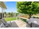 Wooden deck with chairs and a grill, overlooking a well-maintained yard and serene pond view at 8635 Nolan Dr, Fishers, IN 46038