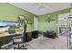 Home office space with a mounted TV, green walls, and access to the upstairs at 8635 Nolan Dr, Fishers, IN 46038