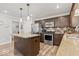 Open kitchen with a large island, granite countertops, and stainless steel appliances at 8635 Nolan Dr, Fishers, IN 46038