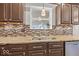 A kitchen sink with granite countertop and tile backsplash adds elegance at 8635 Nolan Dr, Fishers, IN 46038