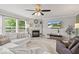 Bright living room featuring plush seating, a fireplace, and large windows at 8635 Nolan Dr, Fishers, IN 46038