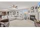 Open concept living room with a fireplace and large windows offering plenty of natural light at 8635 Nolan Dr, Fishers, IN 46038