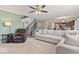 Bright living room with a plush couch, recliner, open staircase, and modern decor at 8635 Nolan Dr, Fishers, IN 46038