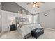 A cozy main bedroom featuring a large bed, accent wall and recessed lighting at 8635 Nolan Dr, Fishers, IN 46038