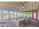 Bright sunroom with neutral furniture and hammocks with multiple views of the outdoors and a red door at 8635 Nolan Dr, Fishers, IN 46038