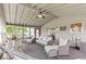 Neutral sunroom with many windows, a ceiling fan, and a sliding door leading to outdoor areas at 8635 Nolan Dr, Fishers, IN 46038