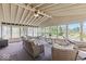 Bright sunroom with large windows, neutral furniture, ceiling fan and relaxing hammocks overlooking a water view at 8635 Nolan Dr, Fishers, IN 46038