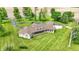 Aerial view of a brick home with dormers, a covered porch, and expansive lawn with mature trees at 893 W 500 S, Anderson, IN 46013
