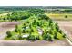 Aerial view of a home surrounded by lush greenery, a pond, and mature trees on a large private lot at 893 W 500 S, Anderson, IN 46013