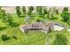 Aerial view of a brick home with dormers and covered porch surrounded by a large grassy yard and mature trees at 893 W 500 S, Anderson, IN 46013