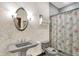 Cozy bathroom with pedestal sink, decorative mirror, and charming shower curtain at 893 W 500 S, Anderson, IN 46013