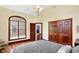 Elegant bedroom features a large arched window, hardwood floors, and a decorative chandelier at 893 W 500 S, Anderson, IN 46013