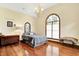 Light-filled bedroom with hardwood floors, arched window, and quaint decor at 893 W 500 S, Anderson, IN 46013