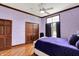 Bedroom features a hardwood floors, lavender colored walls, and a decorative wooden closet at 893 W 500 S, Anderson, IN 46013