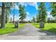 Long driveway leading to a brick home with a lush green lawn and mature trees at 893 W 500 S, Anderson, IN 46013