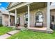 Up-close view of the covered front porch with white columns, seating, and arched windows at 893 W 500 S, Anderson, IN 46013