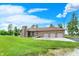 Attached three-car garage on a well-manicured lawn with mature trees at 893 W 500 S, Anderson, IN 46013