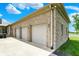 Close-up of an attached three-car garage, featuring neutral-colored doors at 893 W 500 S, Anderson, IN 46013