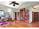 Bright home office with hardwood floors, custom built-in shelving, and a colorful stained-glass window accent at 893 W 500 S, Anderson, IN 46013