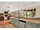 Open kitchen with an eat-in bar, stainless steel appliances, hardwood floors, and an open view to the living room at 893 W 500 S, Anderson, IN 46013