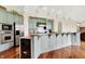 A modern eat-in kitchen with custom cabinets, a stainless-steel refrigerator, and a wine cooler at 893 W 500 S, Anderson, IN 46013