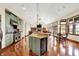 Open concept kitchen with stainless steel appliances and an island that flows into the dining area and living room at 893 W 500 S, Anderson, IN 46013
