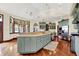 Bright open kitchen with a kitchen island, stainless steel appliances, hardwood floors, and custom cabinets at 893 W 500 S, Anderson, IN 46013
