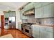 Modern kitchen with stainless steel appliances, custom cabinets, and hardwood floors at 893 W 500 S, Anderson, IN 46013